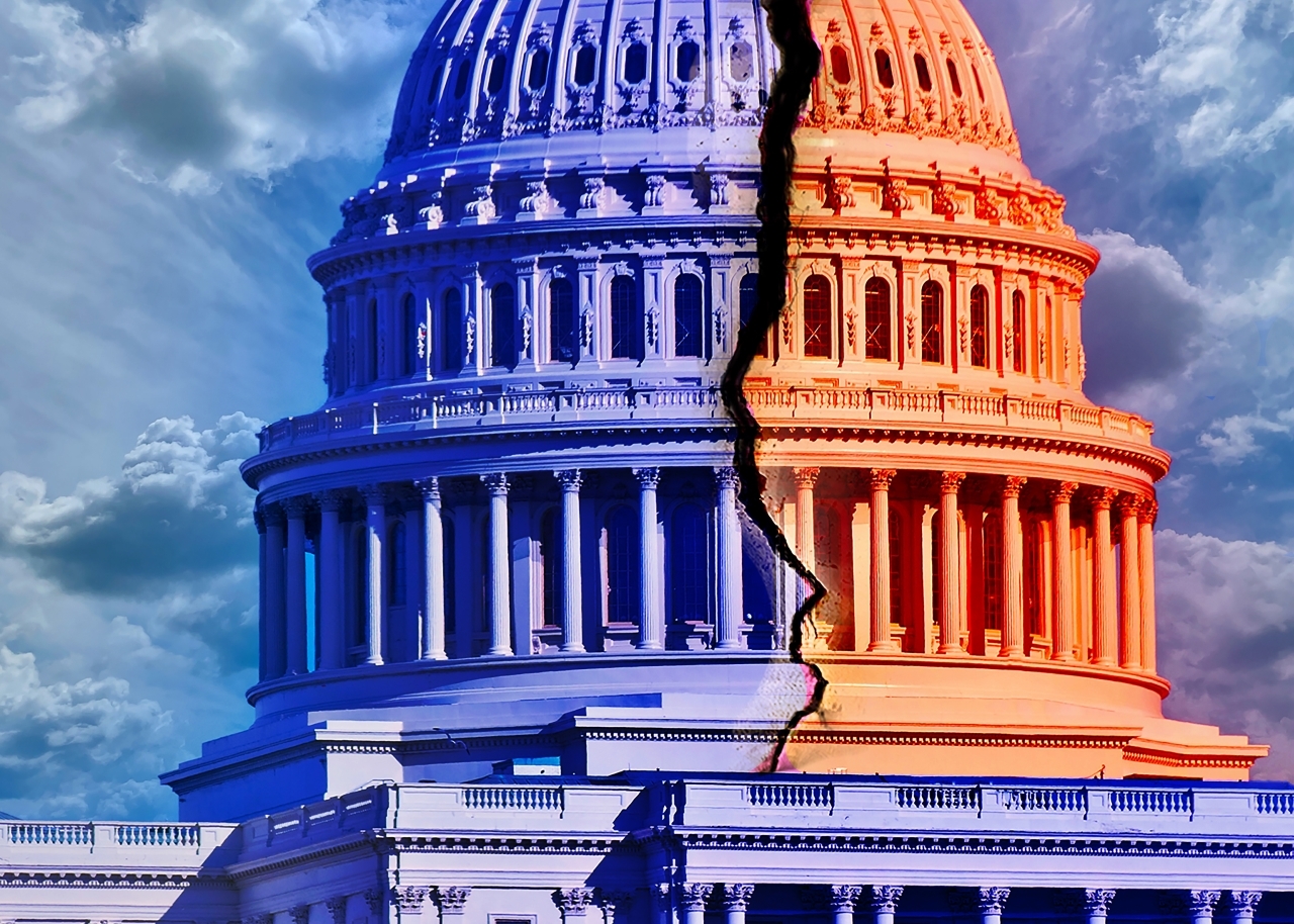 U.S. Capitol building with one side painted blue and the other side painted red and a crack down the middle. 