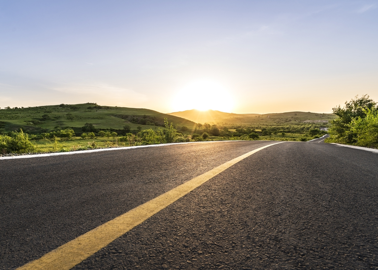 image of a sunset at the end of an highway